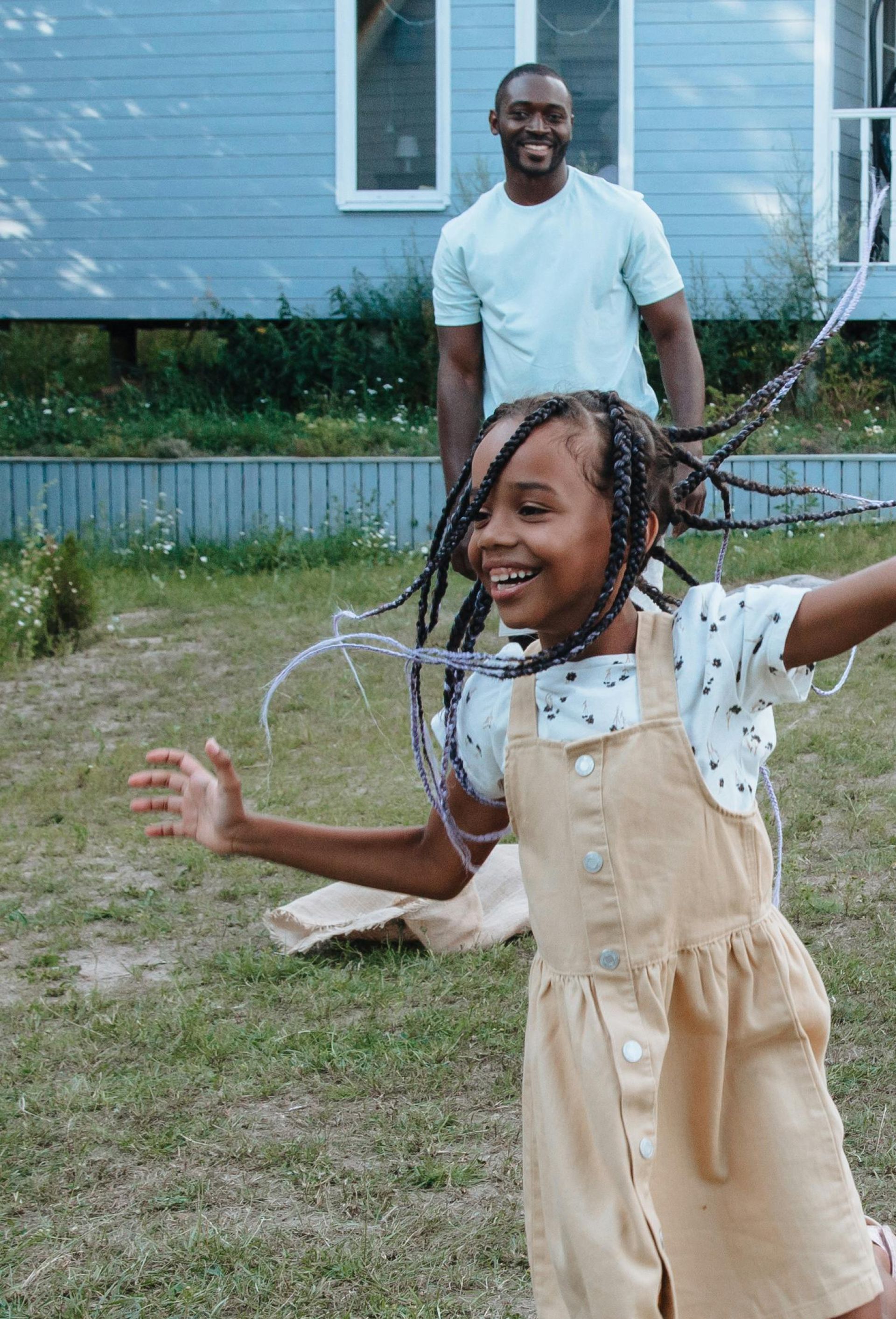 Children enjoy a playful day outdoors in a backyard, celebrating joy and togetherness.